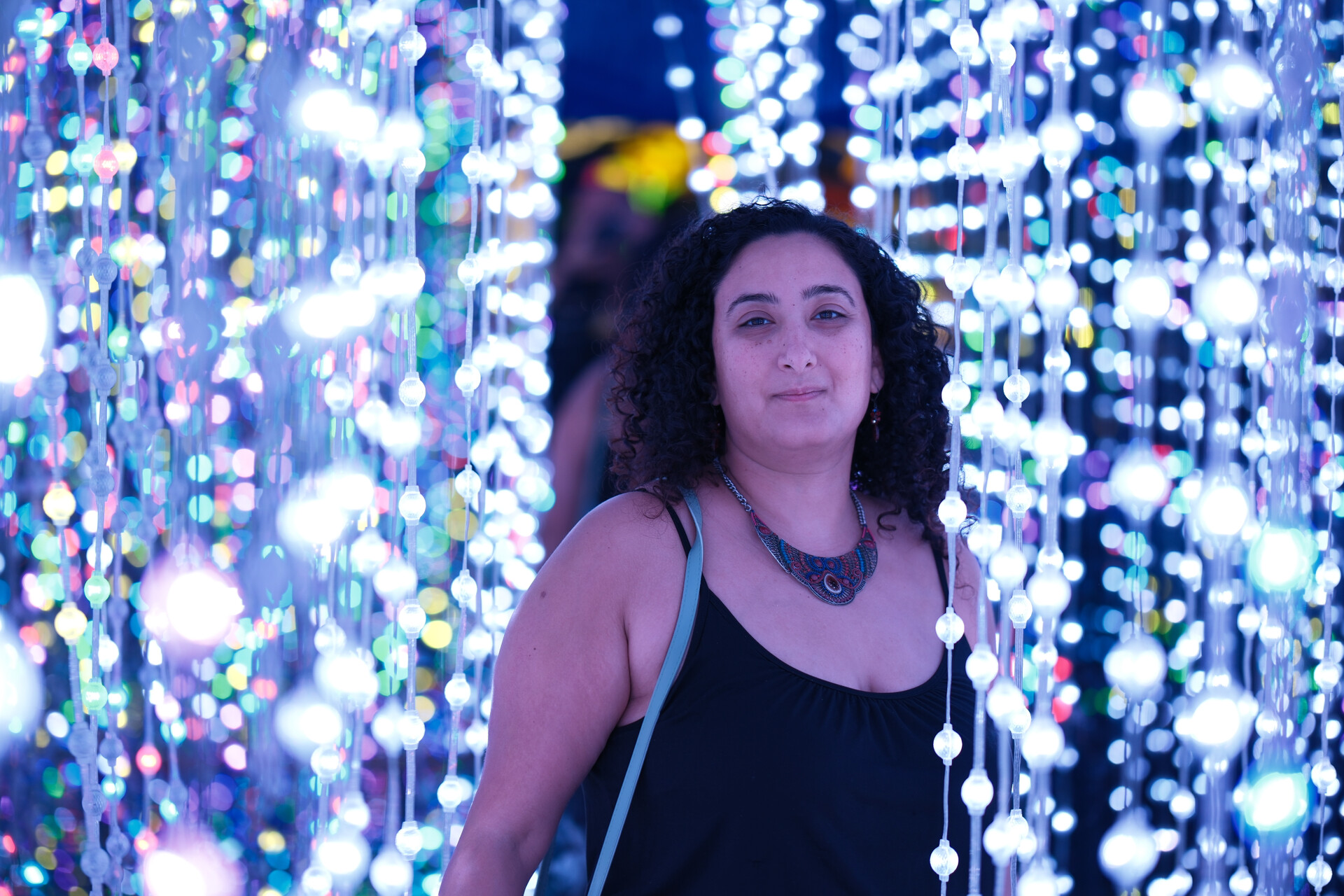 Bunkin' wandering through an enchanted garden of ethereal, colorful lights and glowing orbs.