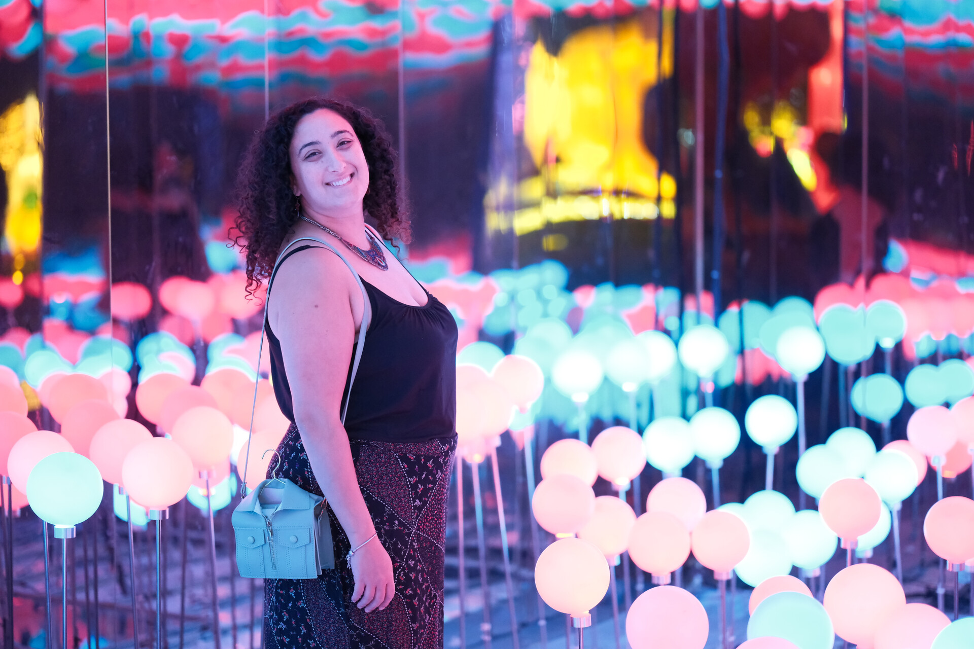 Bunkin' surrounded by a field of magical, glowing light spheres, her smile radiant.