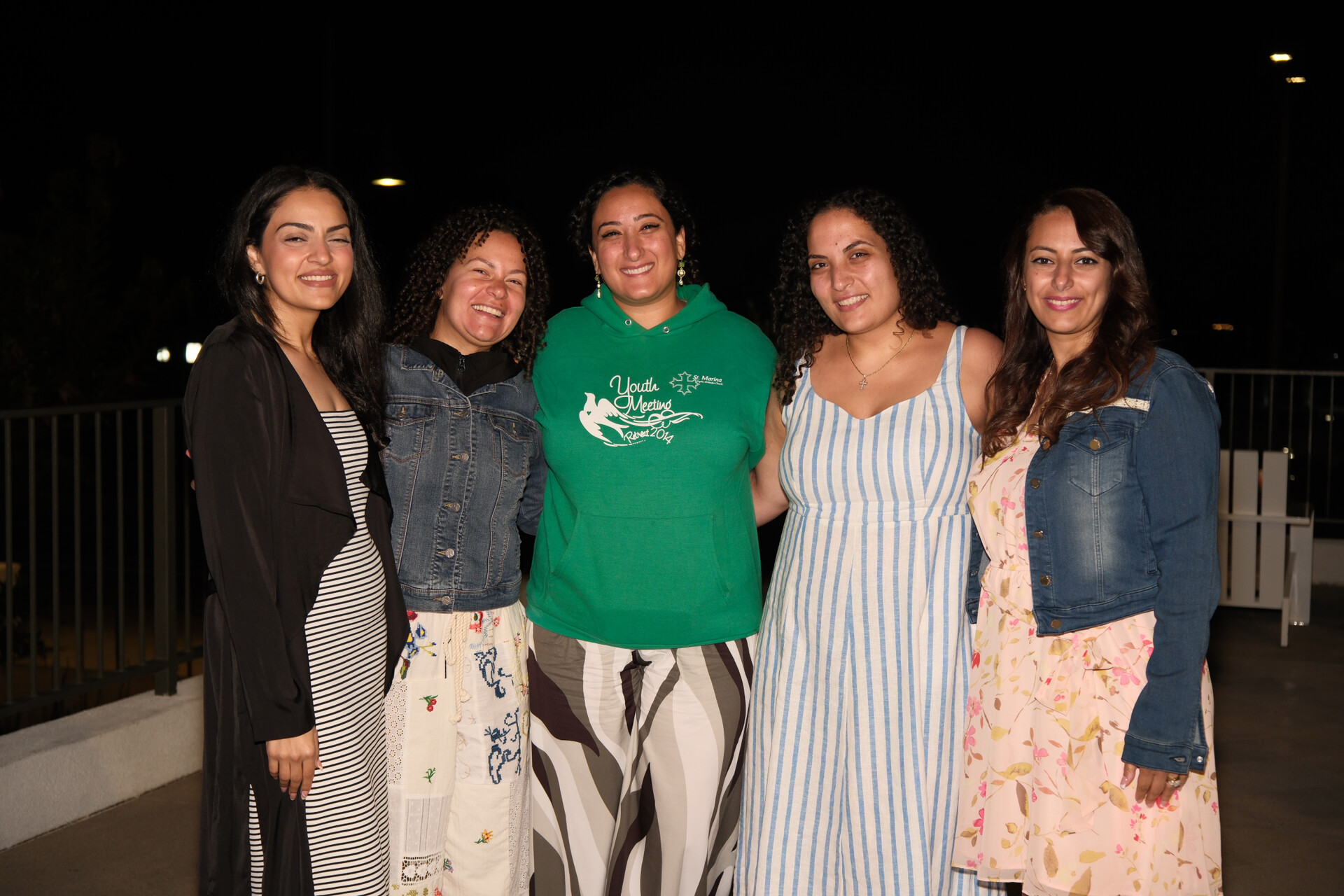 Bunkin' radiating happiness, surrounded by her cherished friends and family in a joyful group photo.
