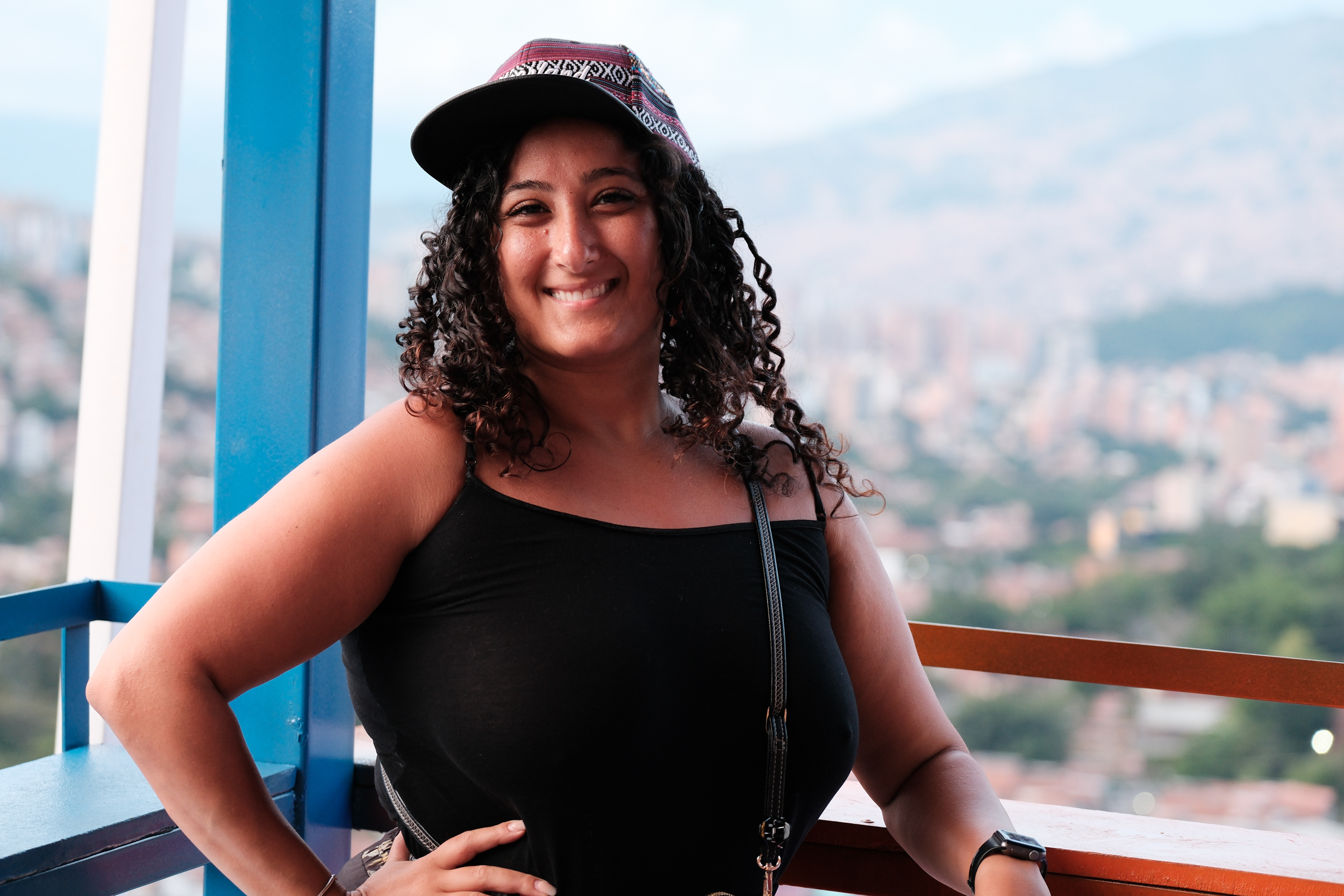 Bunkin' the Urban Explorer, with cap, surveying a city from a scenic overlook.
