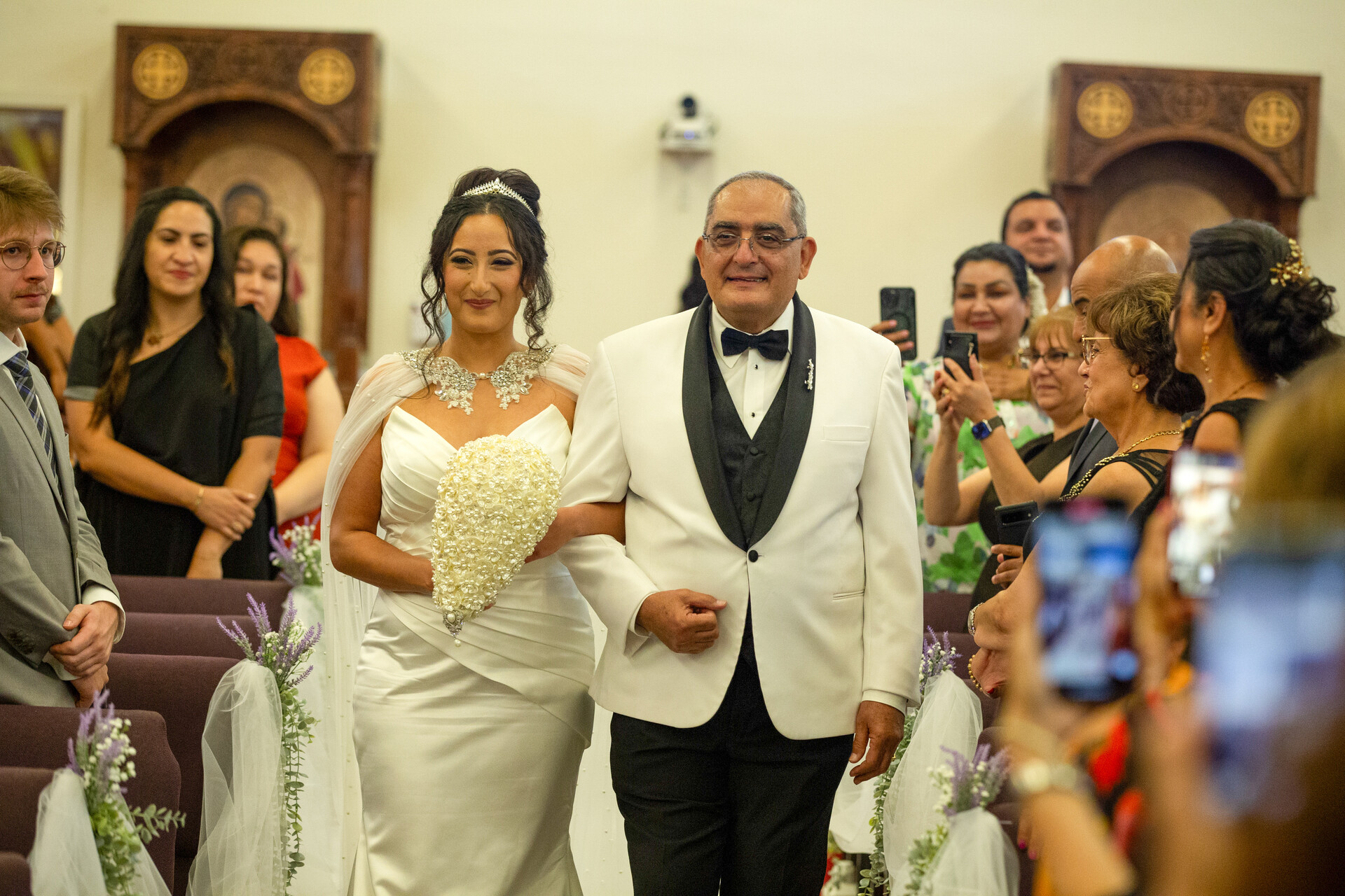 The radiant bride, Bunkin', begins her majestic walk down the aisle with her father.