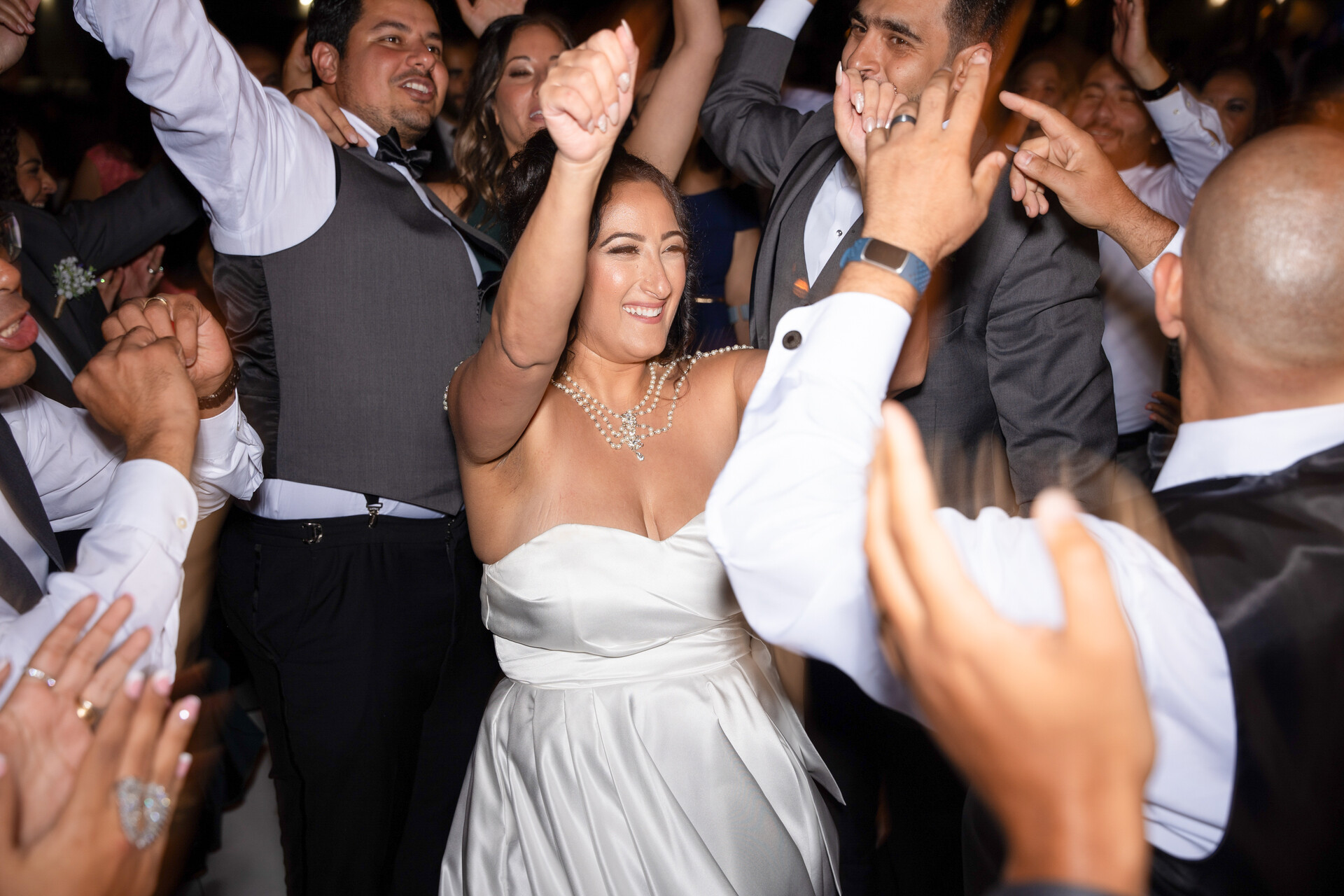 The dance floor alive with energy as Bunkin' and the bridal party celebrate with exuberant joy.