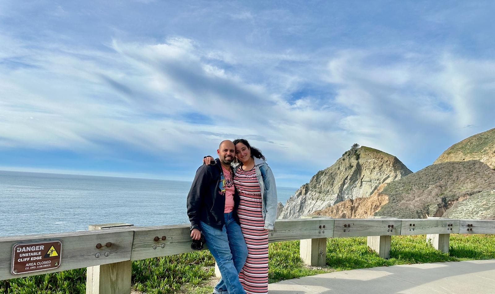 Bunkin' and her partner sharing a happy and scenic moment on a clifftop by the ocean.