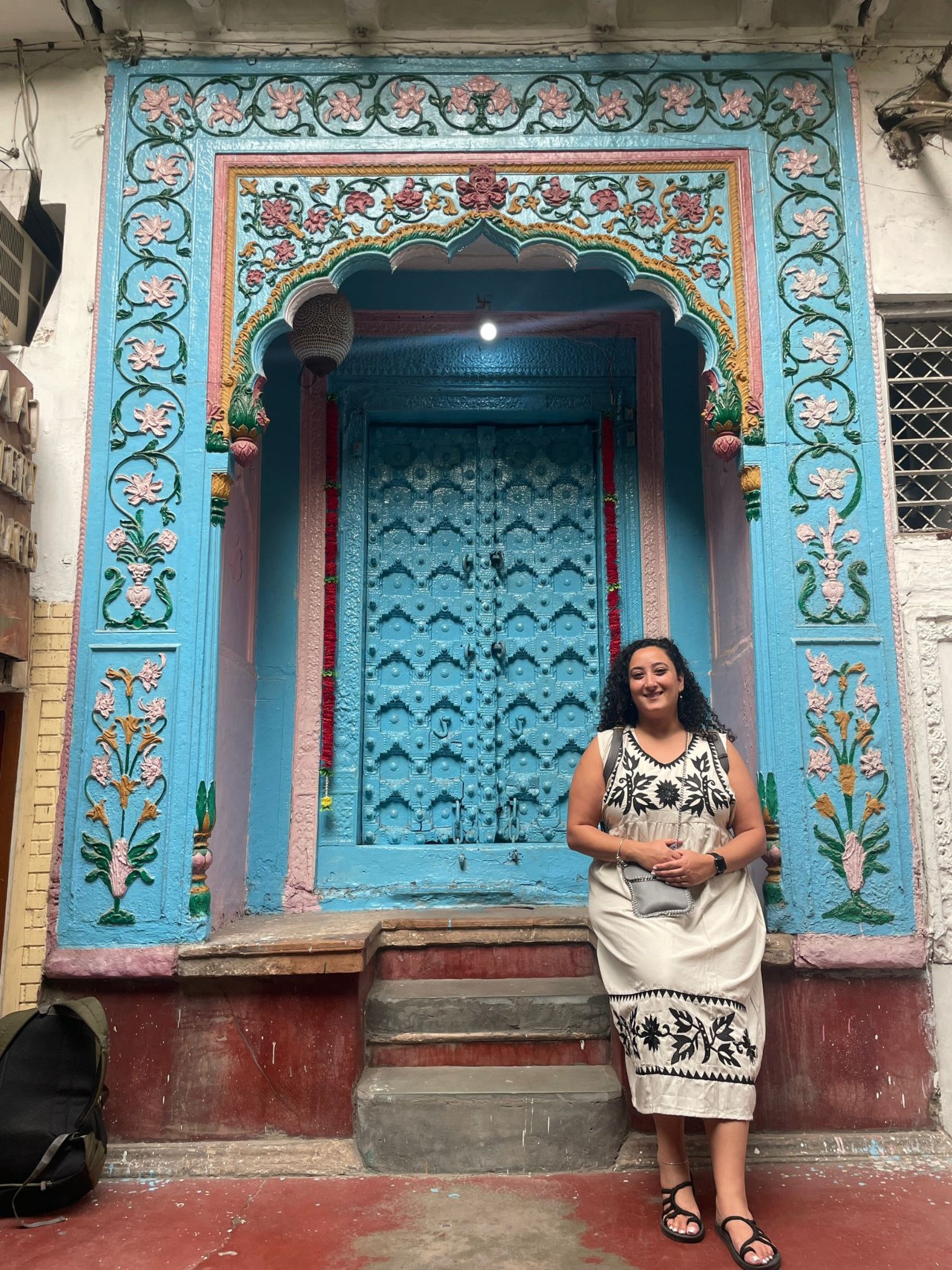 Bunkin' poised before an ancient and ornately carved doorway, a portal to India's wonders.